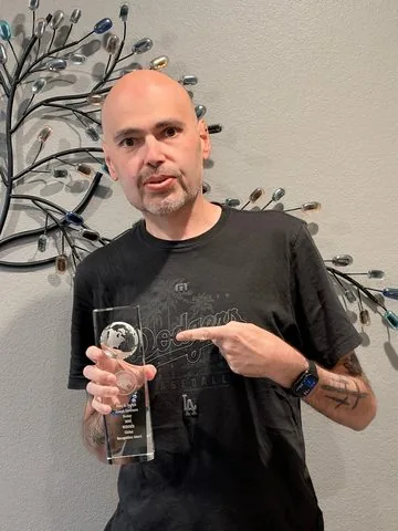Peter Joseph holding his 2026 Global Recognition Award